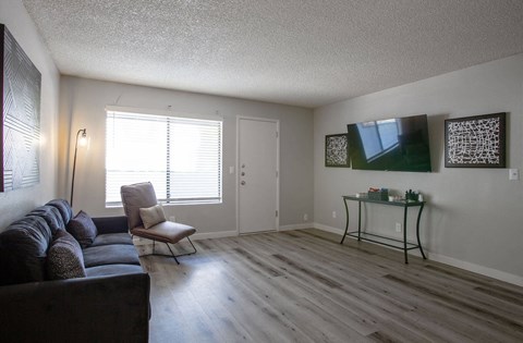 a living room with a couch and a chair and a table